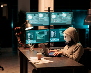 hacker sitting at a desk provi