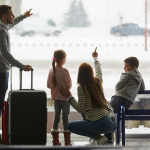 family at the aiport watching planes before travelling